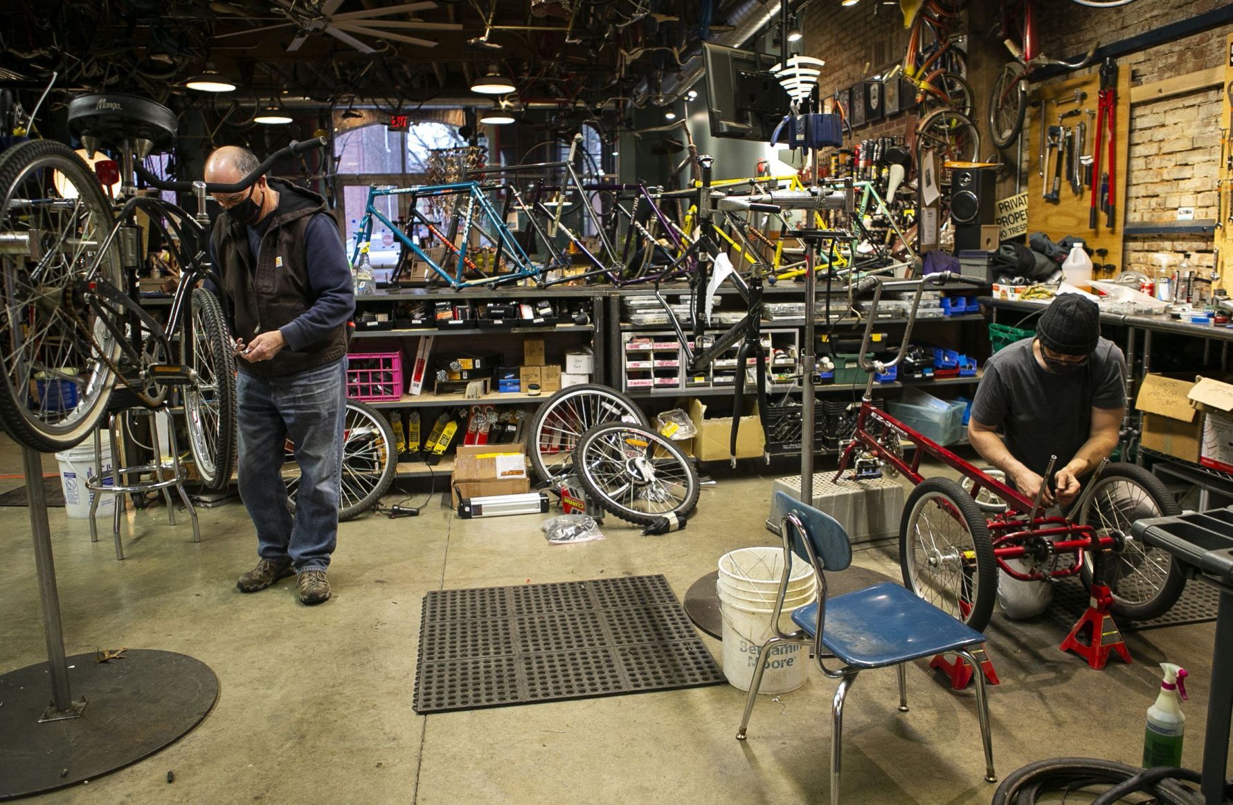 Volunteers and employees repair bikes at St. Louis BWorks in Soulard
